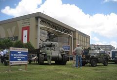 Exterior view of the National World War II Museum in New Orleans with M4A3E9 Sherman tank and jeeps on display