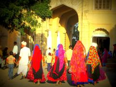 people gathered at a fort with ancient architecture