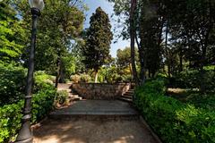 A scenic view of Jardins de Laribal on Montjuïc in Barcelona, featuring lush greenery and a serene pathway on Passeig de Santa Madrona.