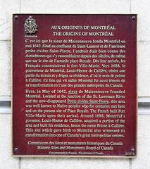 Plaque titled 'Aux origines de Montréal' at the Éperon building of Pointe-à-Callière in Montreal