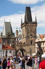 Charles Bridge in Prague at sunset with a view of historical buildings and the Vltava River