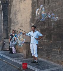 Street artist blowing soap bubbles in Prague