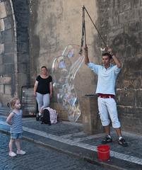 street artist blowing soap bubbles