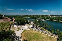 Panoramic view of Avignon ramparts, Pont Saint-Bénézet, and Rhône valley from Jardin des Doms