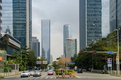 Aerial view of Shenzhen cityscape with skyscrapers and lush greenery