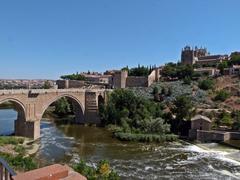 View of Toledo over Tajo River with Puente de San Martin and Monasterio de San Juan de los Reyes