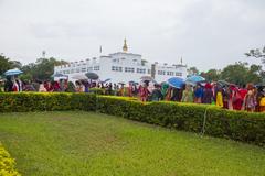 Buddha Jayanti celebration with a large Buddha statue and devotees in a park