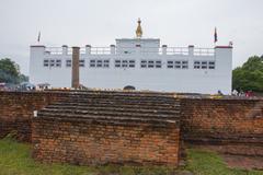 Buddha Jayanti celebration with Buddha statue and people praying