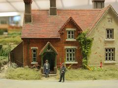 Photograph of a model house with a vicar at Pendon Museum