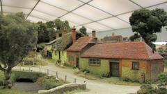 colorful model countryside scene with a red postbox and a traditional English cottage