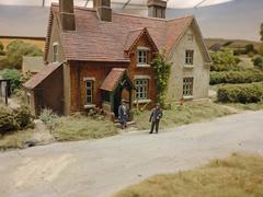 Photograph of a miniature scene depicting a vicar visiting a household, taken at Pendon Museum in Oxfordshire