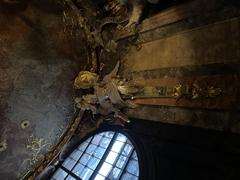 Asamkirche Munich vestibule angel statue with flaming sword, helmet, and shield above entrance door