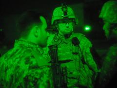 US soldiers inspect Iraqi checkpoint at night in Baghdad