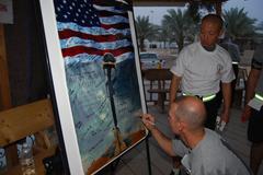 Soldiers completing a 5K Veterans Day run writing on a memory poster