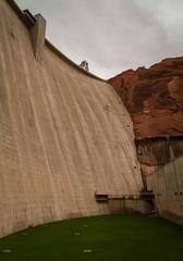 Dam with grass and powerhouse in the background