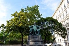 Statue of Goethe surrounded by trees in a park in Vienna, Austria