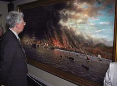 Man observing painting of flames and smoke depicting 1906 San Francisco earthquake and fire