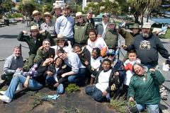 group of children and adults smiling near garden at Aquatic Park