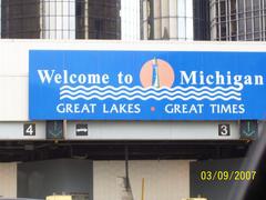 Detroit Windsor Tunnel exit with toll booths and Michigan state welcome sign