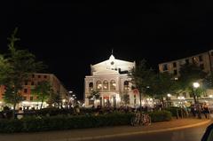 Gärtnerplatz square at night with illuminated Gärtnerplatztheater in the background