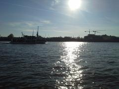 A serene waterfront view in Bandar Humburg with boats docked and buildings in the background