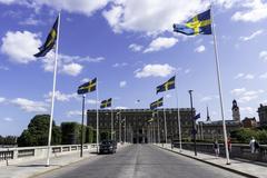 Norrbro bridge in Stockholm with flags and the royal palace in the background