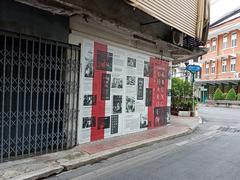 narrow street with traditional Chinese signage and a motorbike in Talat Noi quarter