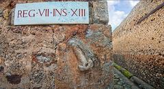 Sign pointing to the brothel in Pompeii