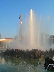 fountain in a park with clear water cascading from multiple tiers