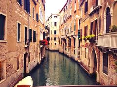 Venezia canal between old buildings with Palazzo Contarini del Bovolo on left