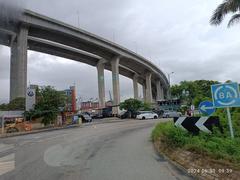 View of Stonecutters Island, Stonecutters Bridge, and Tsing Sha Highway flyover in Hong Kong, June 2024