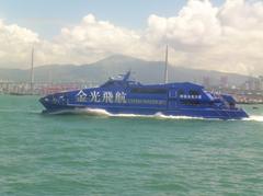 Cotai Jet ferry St. Mark in Hong Kong harbor with Stonecutters Bridge and Tian Mo Shan in background