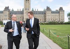 Andrew Scheer and Luc Berthold walking in front of the Canadian Parliament