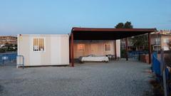 sunrise view of construction site cabins at Illeta dels Banyets archaeological site