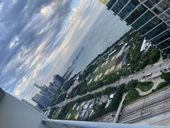 Grant Park in Chicago with Lollapalooza stages set up, Buckingham Fountain in the center, and Lakeshore East in the background