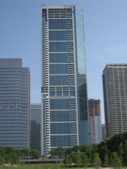 modern high-rise building with glass facade on a sunny day