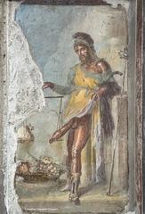 Fresco of the fertility god Priapus weighing his phallus against a sack of money