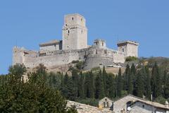 Scenic view of Assisi, Italy, with historic buildings and green hills in the background