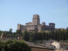 Scenic view of Assisi, Italy featuring traditional buildings and lush greenery