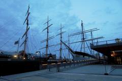 Square-rigged ships at Pier 17 during twilight