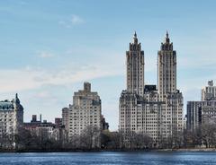 A scenic winter view of Central Park in New York City with snow-covered trees and paths