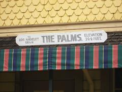 Palms Depot train station sign displaying 'THE PALMS', 'ELEVATION 144 FEET', and 'TO LOS ANGELES 13 6/10 M'