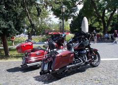 Two Harley-Davidson Street Glide motorcycles in front of Zero Kilometre Stone in Budapest