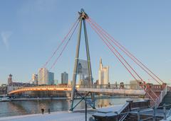 Bridge Holbeinsteg over the river Main during sunset with city skyline, Frankfurt, Germany