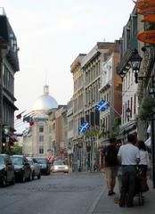 Silver dome of Marché Bonsecours along rue St Paul at night