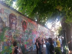 John Lennon Wall in Prague with colorful graffiti featuring various themes related to John Lennon and The Beatles