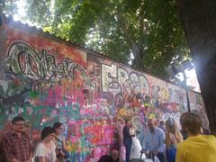 John Lennon Wall in Prague covered with vibrant graffiti and messages of peace and love