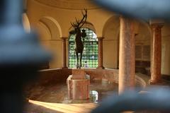 Hubertusbrunnen statue with a bronze stag in Munich