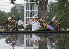 Adm. Harry Harris and Bangladesh Army members saluting during wreath laying ceremony at Skikha Anirban eternal flame in Dhaka