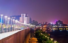 Ahmedabad riverfront at sunset with modern buildings and promenade